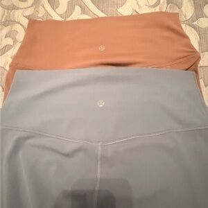 2 pairs lululemon leggings in Rust Pink and Light Blue